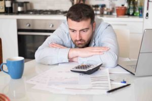 man looking at the energy bill stressed