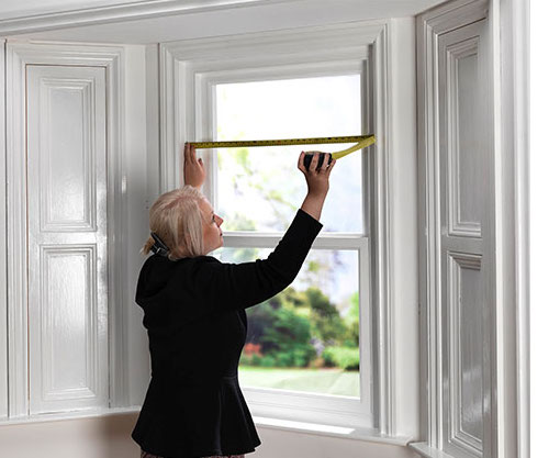Woman Measuring WIndows