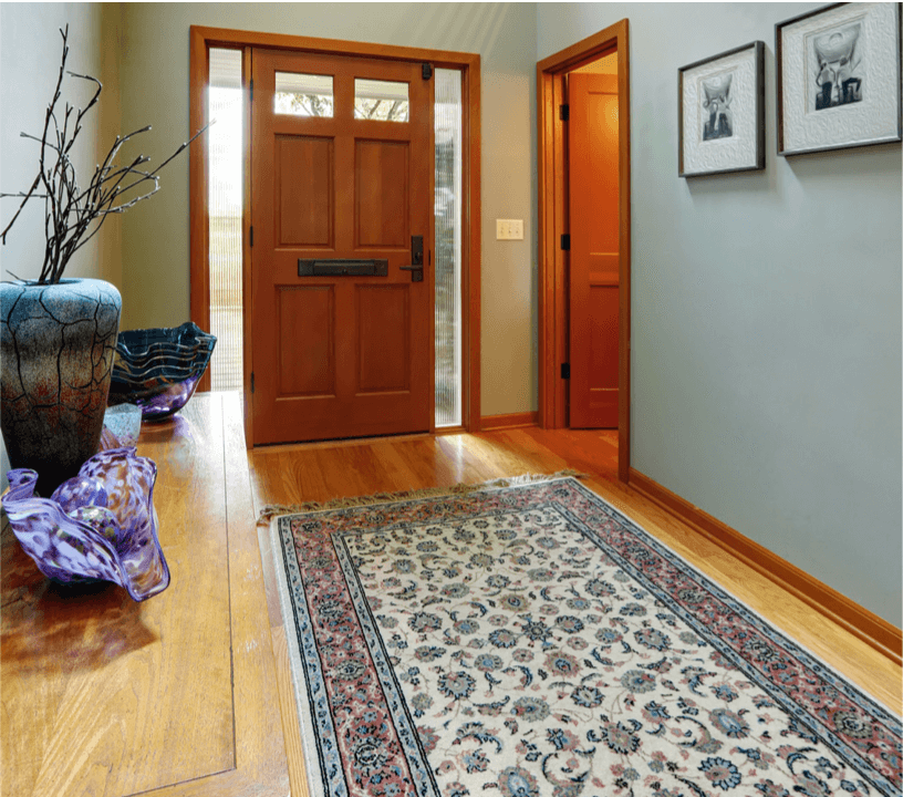 Entryway decor rug, wall art, and entry door