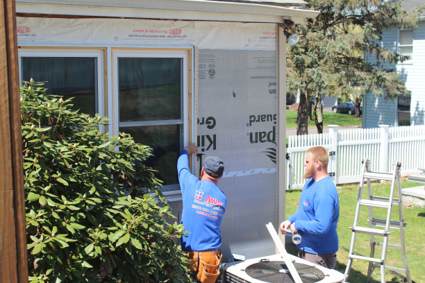 action shot of siding installation in the Windham county area by AWS