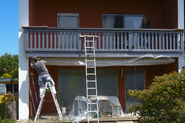 Man Painting House