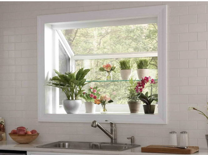 Garden window set in kitchen with plants resting on the window sill and glass shelf